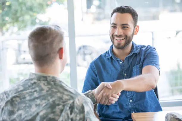 Recruiter shakes hand with new military recruit